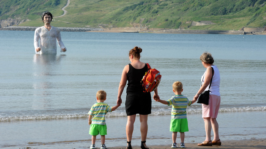 Here he is, definitely not menacing this nice family on their beach vacation.